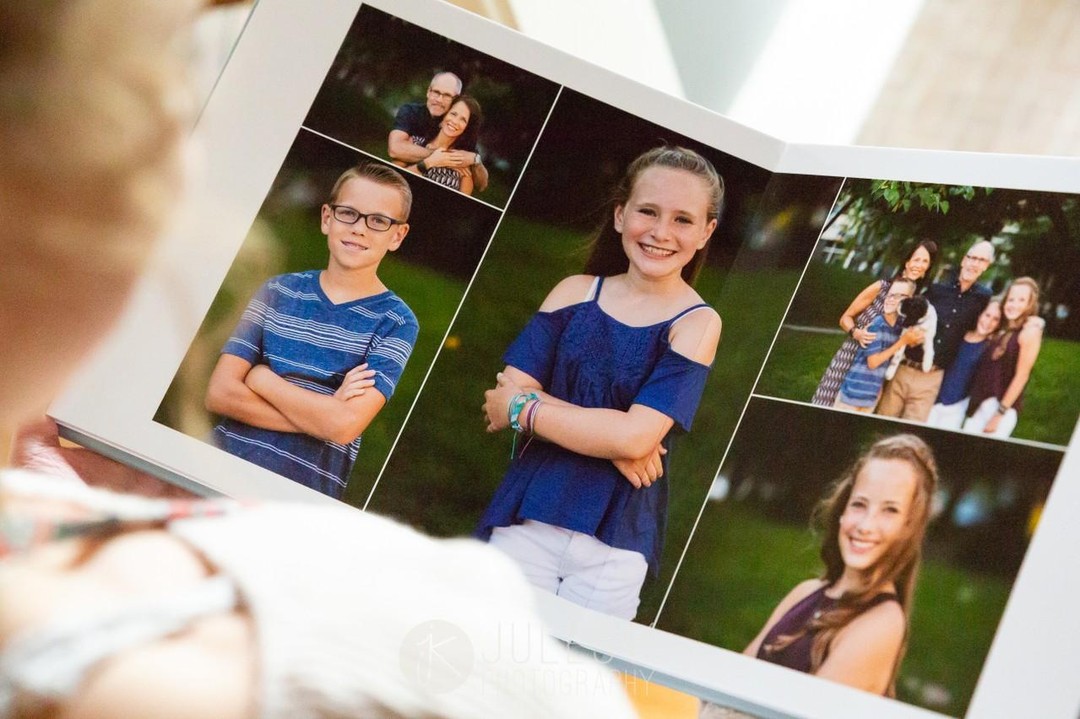 Person looking through a signature album of family portraits