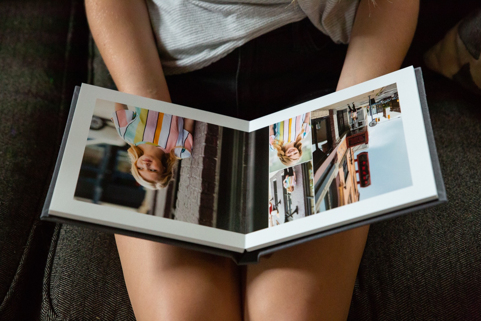 Person sitting and looking through a signature photo album