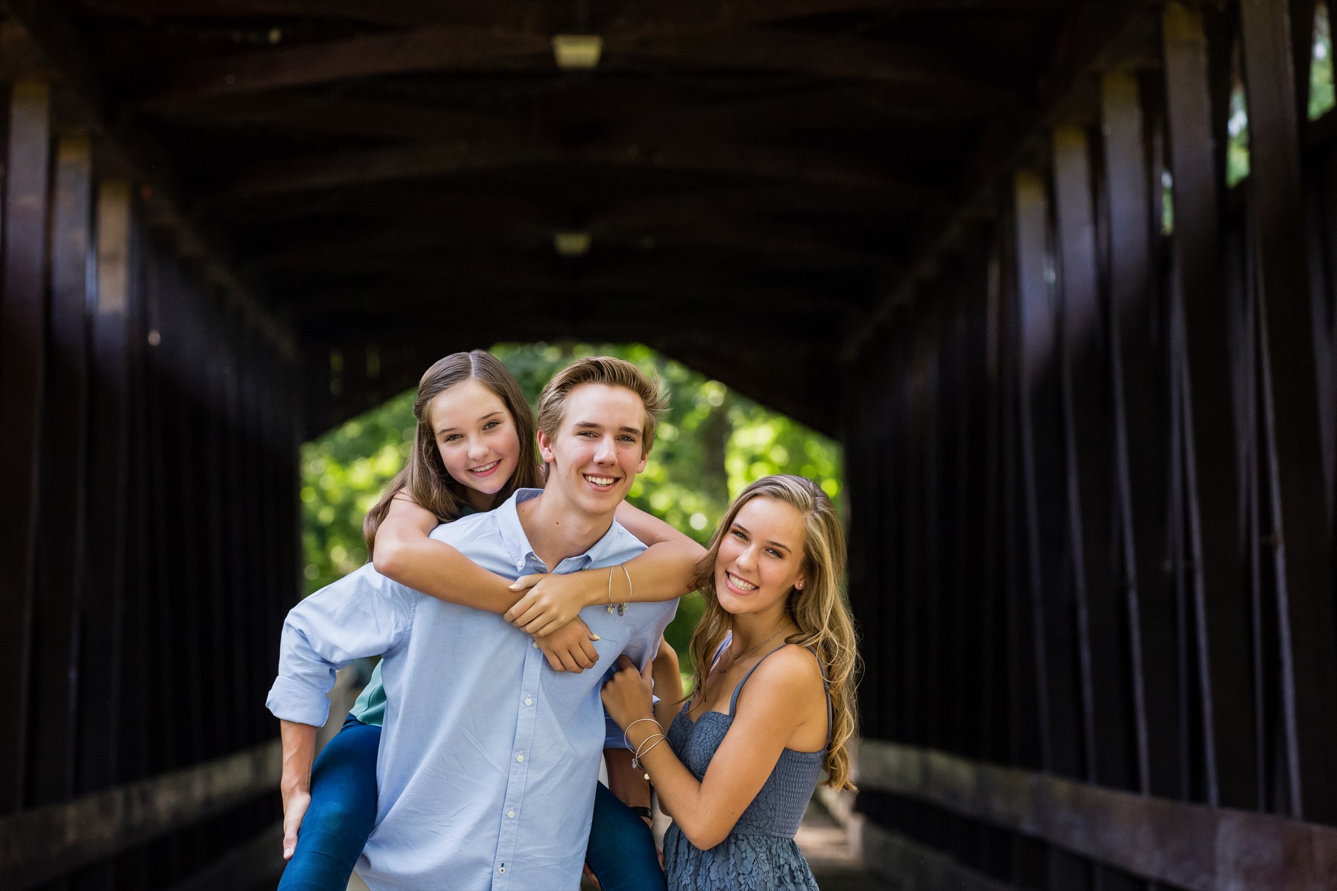 Three siblings at the Ada Covered Bridge Michigan Jules K Photography