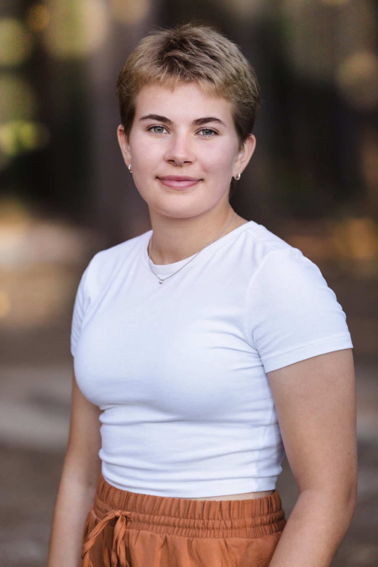 Senior portrait among the white pines at Provin Trails Grand Rapids Michigan Jules K Photography