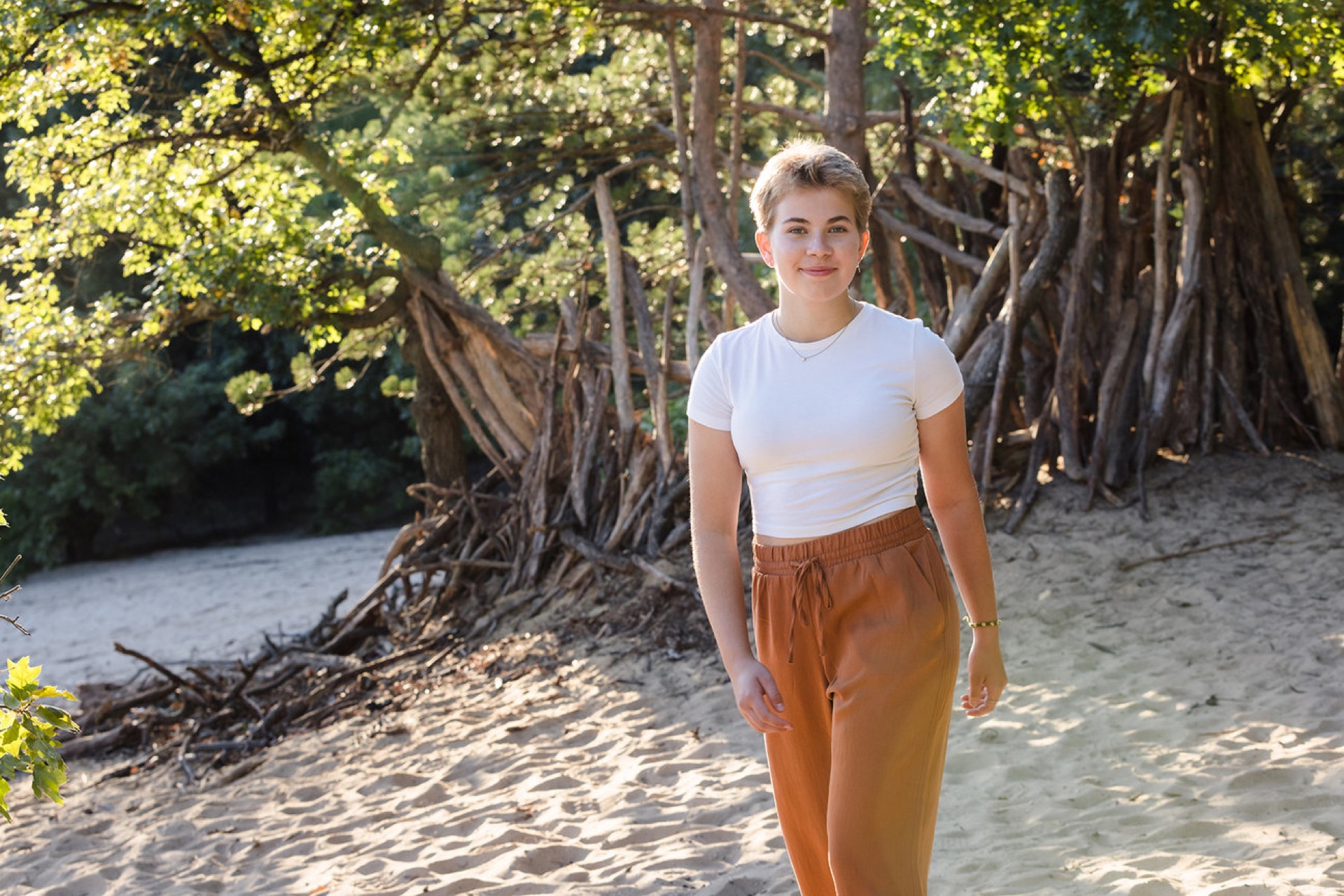 Senior portrait in Provin Trails pine forest Grand Rapids Michigan Jules K Photography