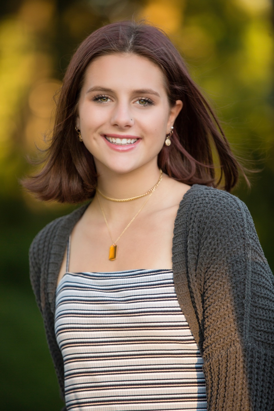 Senior portrait with cardigan layered over the same outfit in downtown Grand Rapids Michigan — Jules K Photography