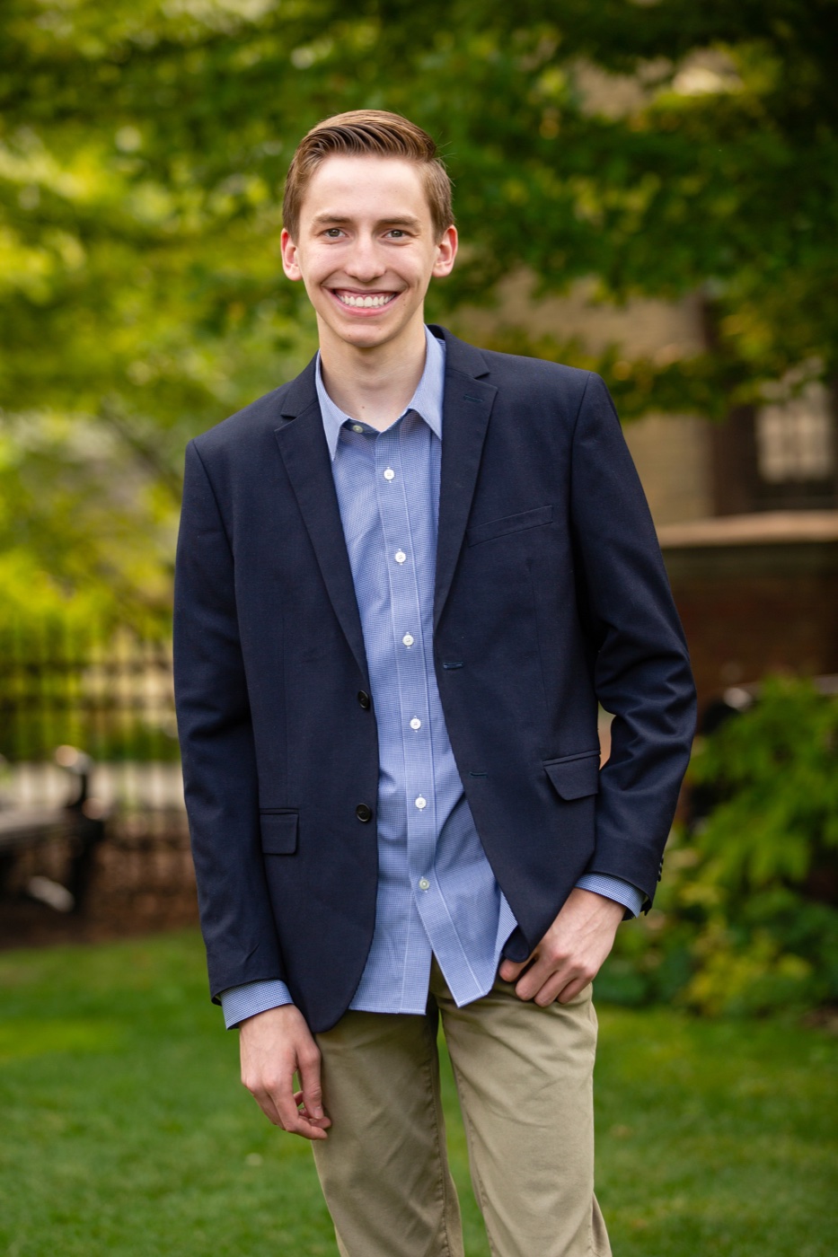 Senior guy wearing a jacket over a button-down shirt in downtown Grand Rapids Michigan — Jules K Photography
