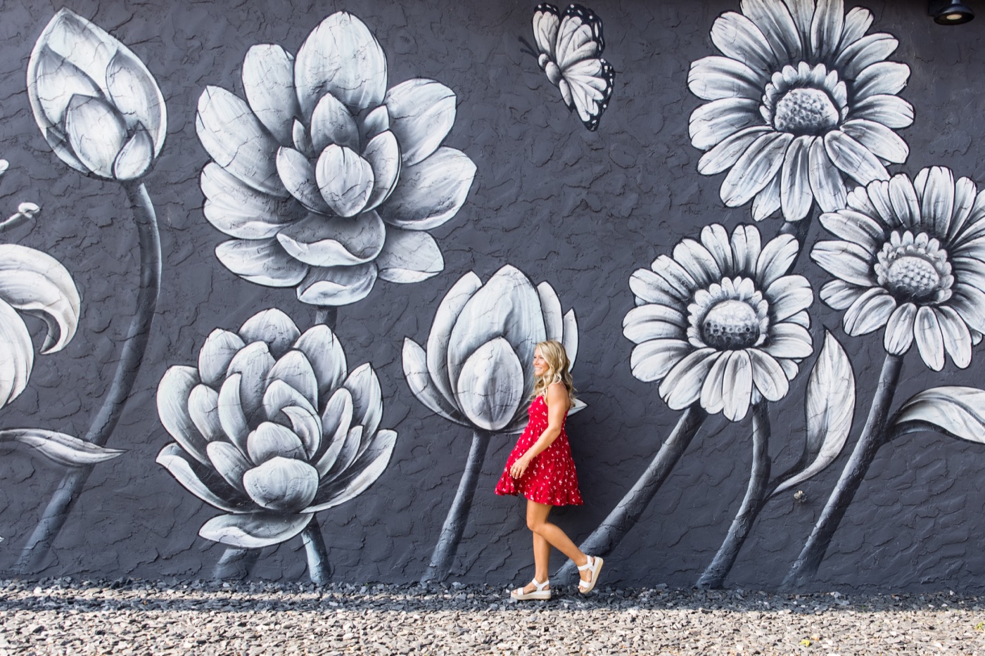 Senior in a red dress in front of a mural on 8th Street in Holland Michigan — Jules K Photography