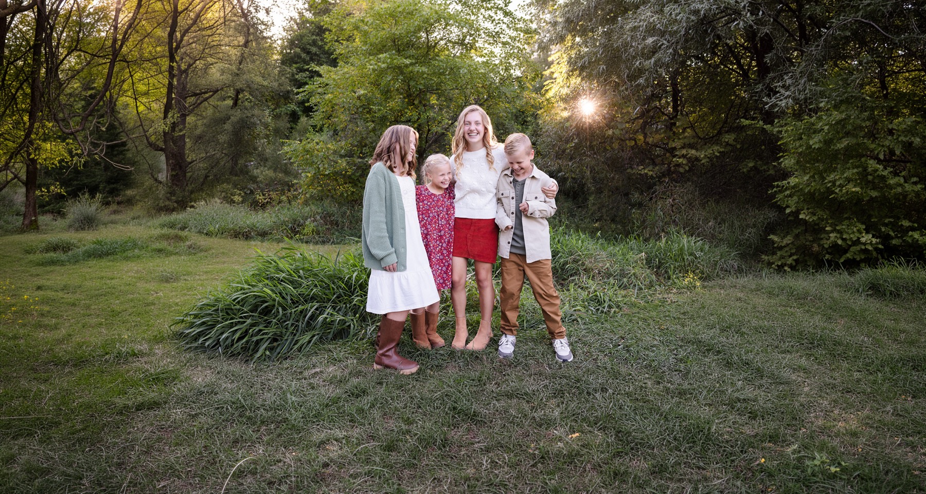 Grand Rapids family laughing together during outdoor portrait session