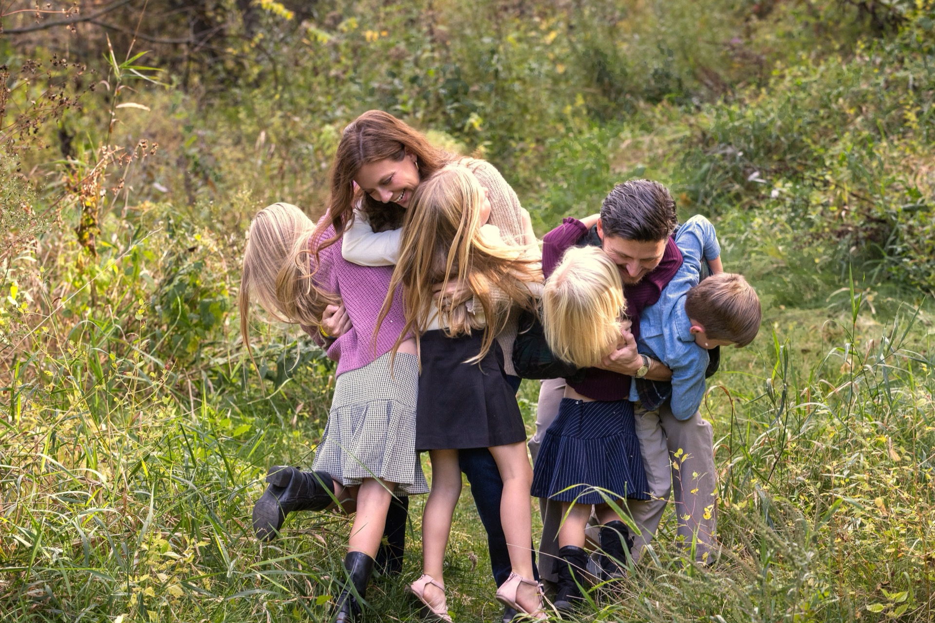 Family laughing together during portrait session West Michigan