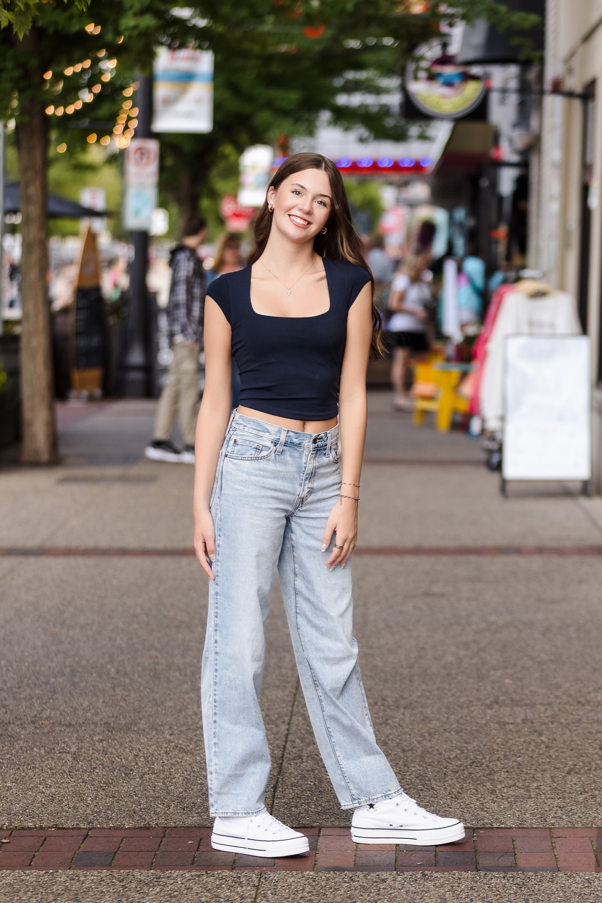 High school senior girl smiling on downtown Grand Haven Michigan street