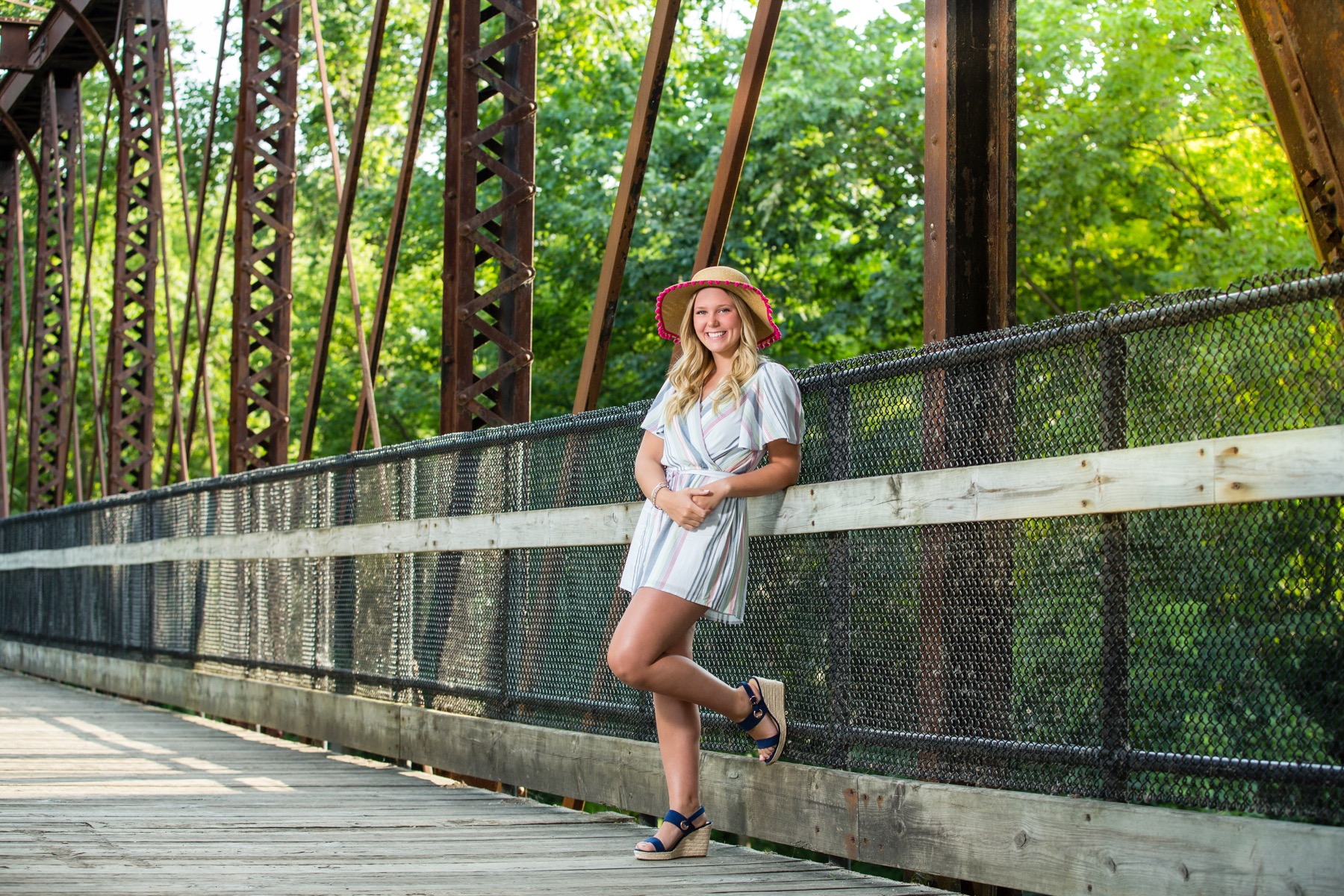 Senior girl on iron footbridge along the river in Rockford Michigan